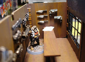 Dave Ruskin behind the counter. The newspaper is a copy of Weekly World News (because they have the best headlines), printed on my computer.